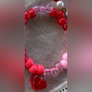 Clear pink and red pony bead bracelet with gigantic red heart.